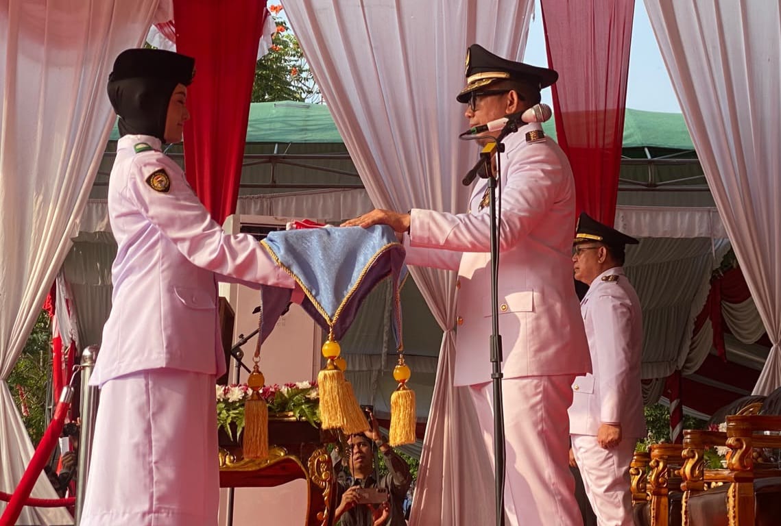 Bupati OKU H Teddy Meilwansyah SSTP MM MPd menyerahkan duplikat bendera pusaka untuk dikibarkan pada HUT ke-81 RI di Taman Kota Baturaja, Senin(17/8/2026). Kanalberita.id / Edo